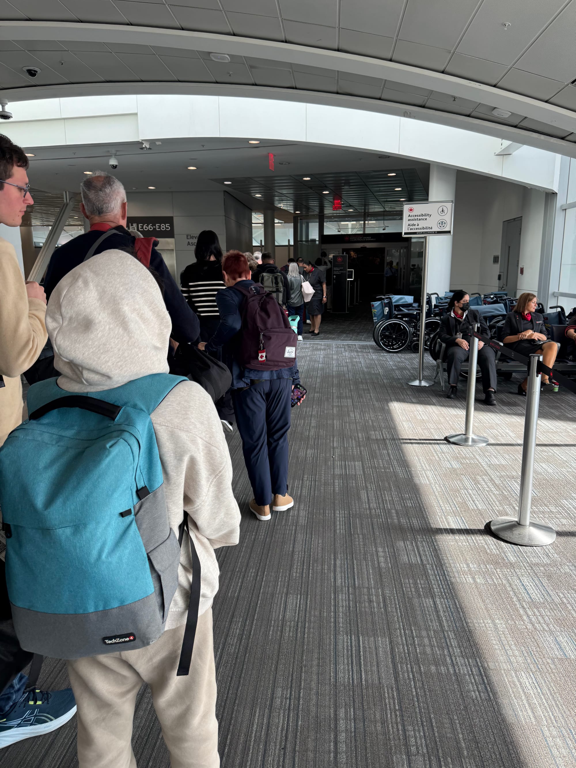 A long queue outside the Air Canada Maple Leaf Lounge at Toronto Pearson YYZ.