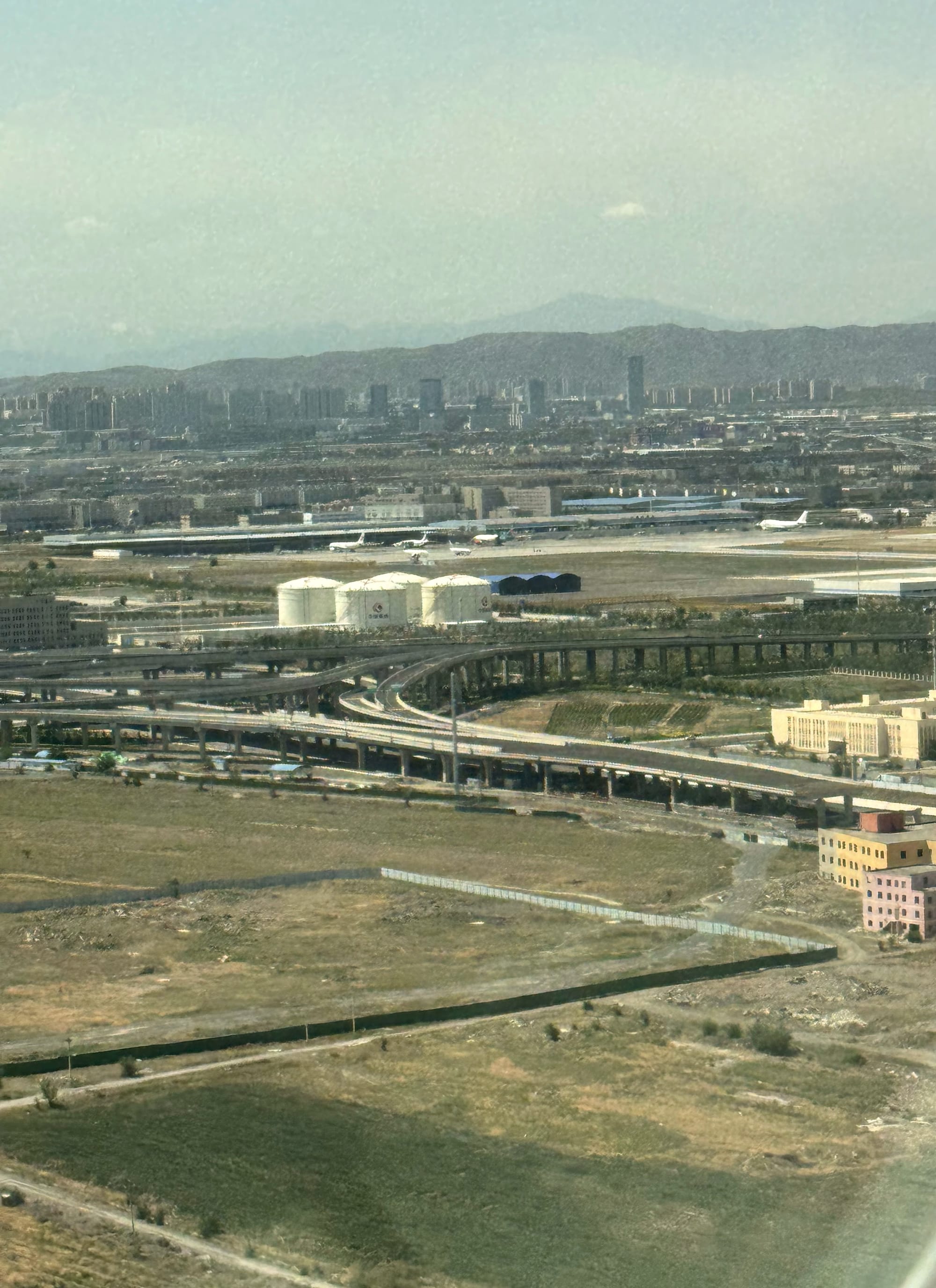 Approach into Urumqi, with the city and mountains below
